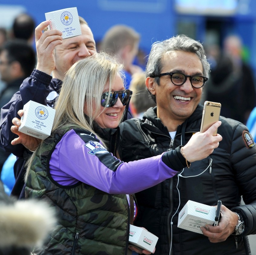 Foxes fans are treated to a Leicester City Football Club Krispy Kreme doughnut. 30,000 doughnuts were given away to fans courteously of Mr. Vichai, wanted to personally thank the Leicester faithful for their unwavering support for his team.