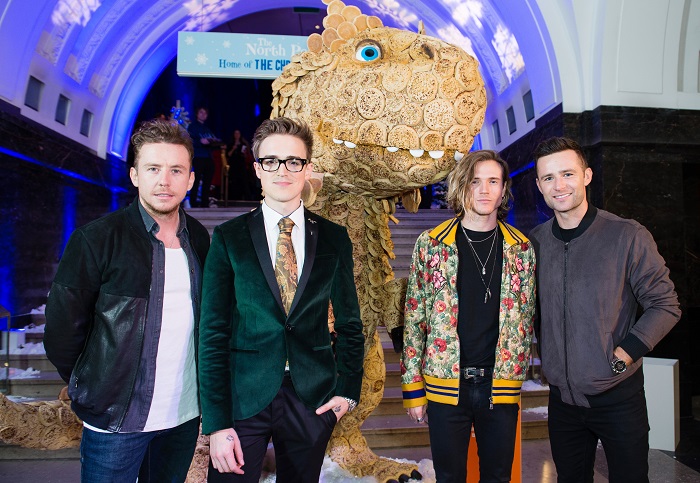 LONDON, ENGLAND - OCTOBER 05:  (L-R) Danny Jones, Tom Fletcher, Dougie Poynter and Harry Judd from McFly meet the 'Giant Crumpet Christmasaurus'. Warburtons created a 'Giant Crumpet Christmasaurus' crafted from Warburtons Giant Crumpets, marking the launch of Tom FletcherÍs new book, The Christmasaurus  at Natural History Museum on October 5, 2016 in London, England.  (Photo by Jeff Spicer/Getty Images for Warburtons)