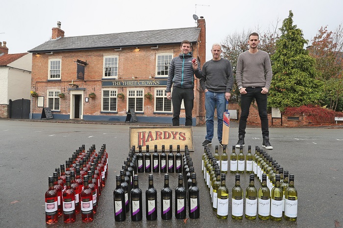 LOUGHBOROUGH, ENGLAND - NOVEMBER 09: Co Owner of the Three Crowns Inn Harry Gurney of Nottinghamshire Cricket Club, Head Coach Peter Moores of Nottingham Cricket Club and Alex Hales of Nottingham Cricket Club pose for the camera as they take delivery of 100 cases of Hardy's Wine for Stuart Broad's Pub to mark Broad's 100th Test Cap on November 9, 2016 in Loughborough, England. Hardy's Wine Ambassador Stuart Broad started his 100th Test match for England today against India in Rajkot. (Photo by Christopher Lee/Getty Images for Hardy's) *** Local Caption *** Harry Gurney; Peter Moores; Alex Hales