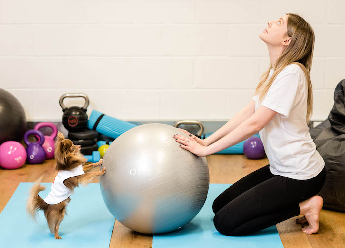 EMBARGOED TO 0001 MONDAY MARCH 19 EDITORIAL USE ONLY Sophia Carey practises yoga with Chihuahua, Lucky as Argos launches the House of Fitness, catering to new workout trends such as ‘Petscercise’, which according to research is the latest workout of choice. PRESS ASSOCIATION Photo. Issue date: Monday March 19, 2018. Research compiled by the retailer found that over half of the UK population prefer to workout at home or in the park, saying that pets offer them much-needed motivation and 46 per cent rely on their pets for moral support, being far less intimidating than their gym goers. Photo credit should read: John Nguyen/PA Wire