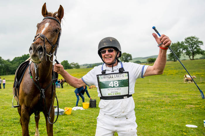 Saturday 09 June 2018 Pictured: Peter Davies on Ronnie the horse were declared winners of the 39th annual Whole Earth Man v Horse race that took place in Britain’s smallest town, Llanwrtyd Wells. Re: Runners and riders from across the world today took part in the 21 mile cross-country Whole Earth Man v Horse race in Llanwrtyd Wells.