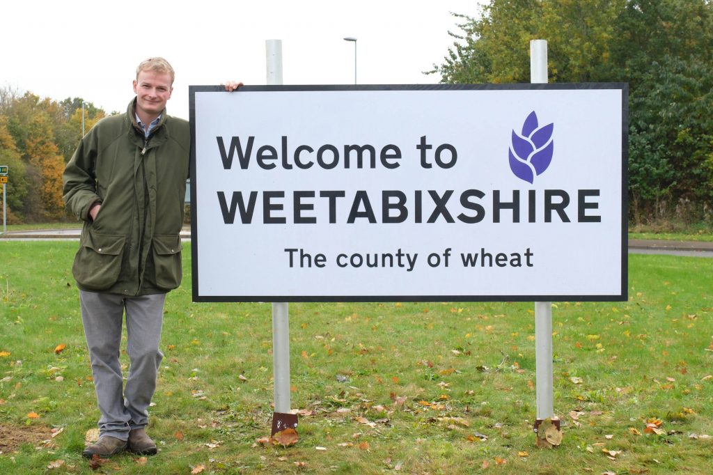 EDITORIAL USE ONLY Jim Beaty, farmer, in front of a ‘Welcome to Weetabixshire’ sign which has been erected in the Northamptonshire town of Burton Latimer to mark the new proposed county lines of Weetabixshire. Picture date: Tuesday November 14, 2023. PA Photo. The breakfast cereal brand is petitioning to create a new county comprising a 50-mile radius from their Mills in Burton Latimer where all the wheat for the cereal is grown. Photo credit should read: Michael Leckie/PA Wire